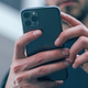A photo of a man holding a phone